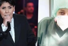 Man in a black suit sings into a microphone on a dim stage; right side shows a masked healthcare worker in green scrubs and a cap.