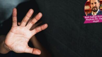 Open hand facing the camera in the foreground, blocking the face against a dark background; circular photo of a man in the top-right corner.
