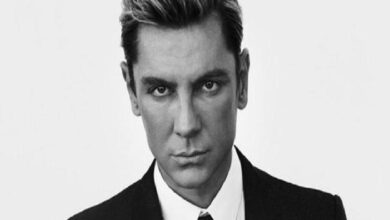 Black-and-white headshot of a man in a suit looking directly at the camera.