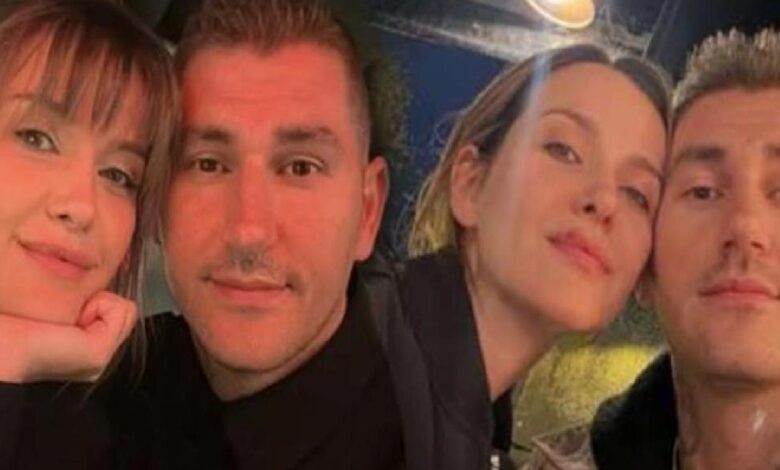 Four friends taking a selfie, leaning in and smiling at the camera.