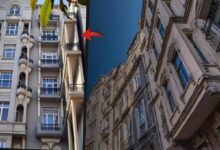 Split view of two ornate apartment buildings with a narrow blue sky gap between them; a red curved arrow highlights the seam between façades.
