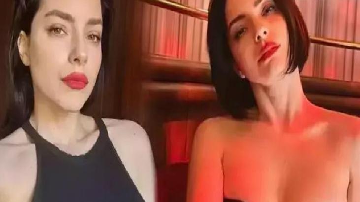 Two women pose for a selfie in a dimly lit setting with red lighting, wearing dark outfits and bold red lipstick.
