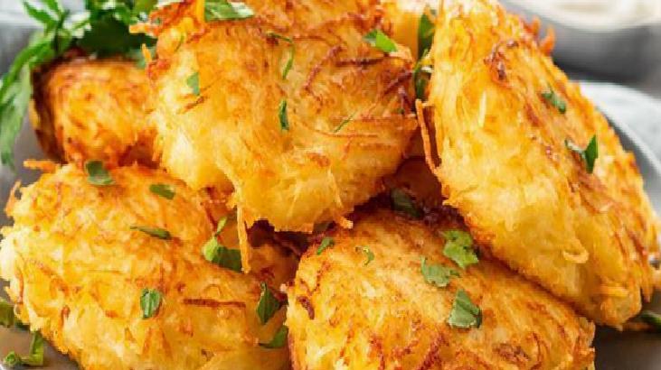 Crispy golden potato croquettes stacked on a plate, garnished with chopped parsley