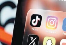 Close-up of a smartphone screen showing social media app icons: TikTok, Instagram, Facebook, Snapchat, and X (Twitter).