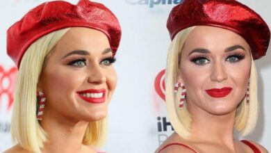 Two women with platinum blonde bob hair, wearing red berets and bold red lipstick, smiling at a backdrop.