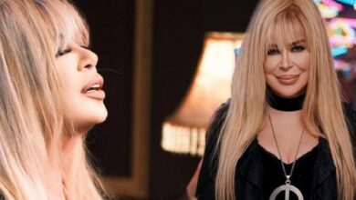 Side profile of a blonde woman on the left and a smiling blonde woman in black with a large circular pendant on the right.