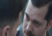 Close-up of a man with a mustache looking intently at another person during a tense moment.