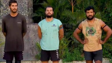 Three men stand side by side outdoors with tropical plants behind them, wearing casual athletic shirts and shorts.