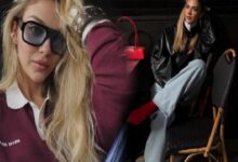 Two fashion models in a backstage setting: a close-up of a blonde wearing oversized sunglasses and a burgundy polo, with a red handbag visible in the background.