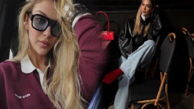 Two fashion models in a backstage setting: a close-up of a blonde wearing oversized sunglasses and a burgundy polo, with a red handbag visible in the background.