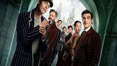 Ensemble cast in 1920s attire posing in a stone archway, like a vintage movie poster.