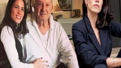 Three people posing indoors: a smiling woman with dark hair on the left, an older man in the center, and a woman in a dark blazer on the right.