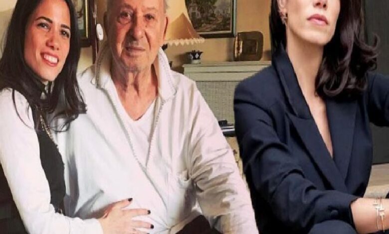 Three people posing indoors: a smiling woman with dark hair on the left, an older man in the center, and a woman in a dark blazer on the right.
